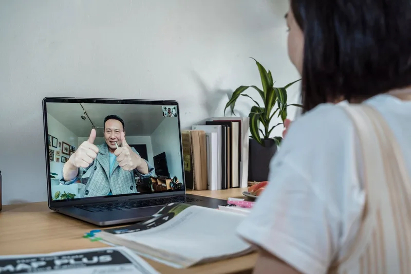 Online coaching session happening over video call on a laptop