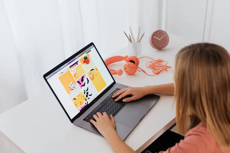 Woman creating digital products at her home workspace with a laptop