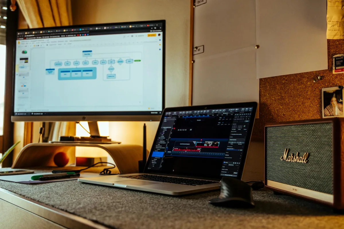 A creator reviewing digital product ideas on a laptop with design tools open