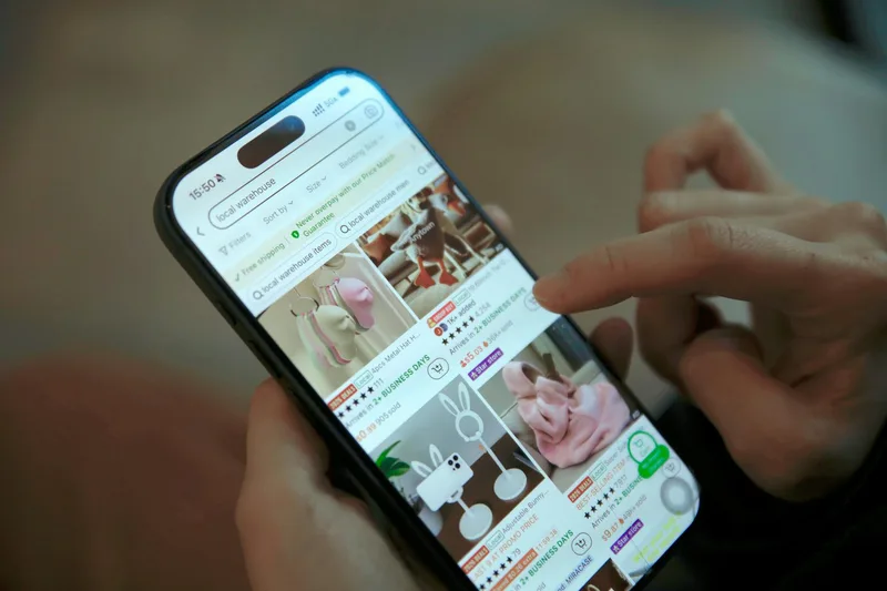 Person browsing an online shopping app on a smartphone, representing an Etsy listing setup