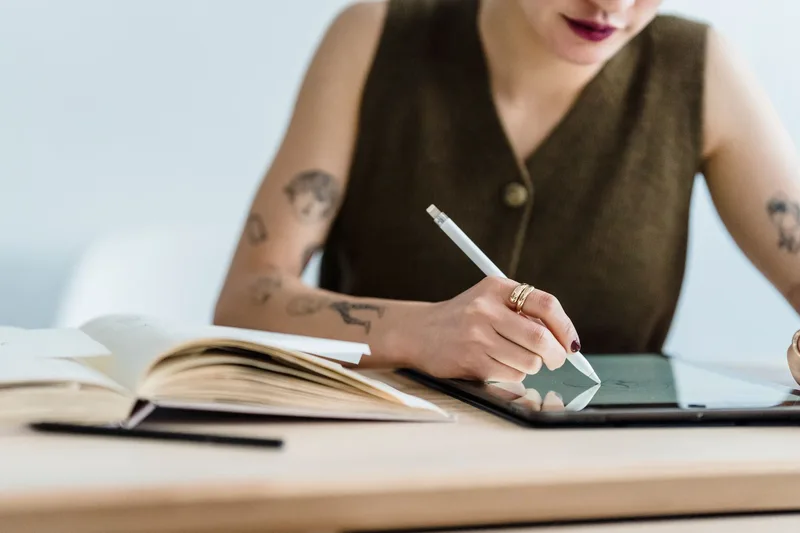 Designer sketching cover design ideas on a graphics tablet