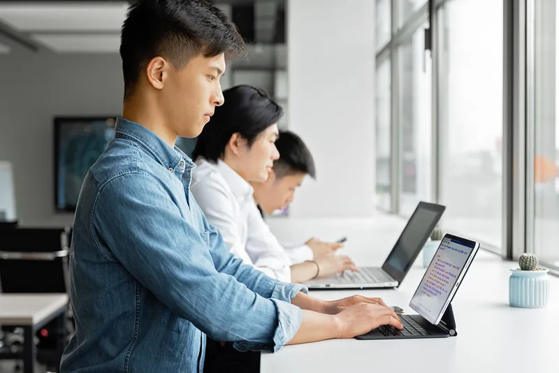Group of creators working together with laptops on platform strategy for digital products