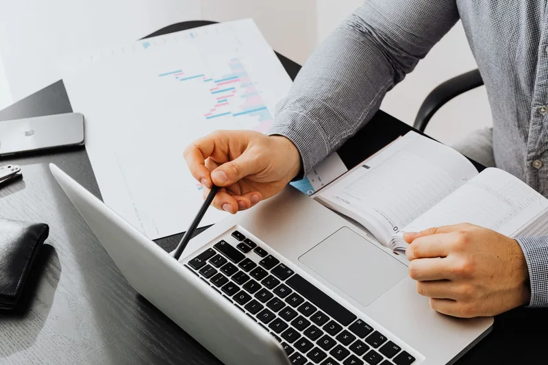 Person reviewing pricing and fee structures on a laptop at a desk