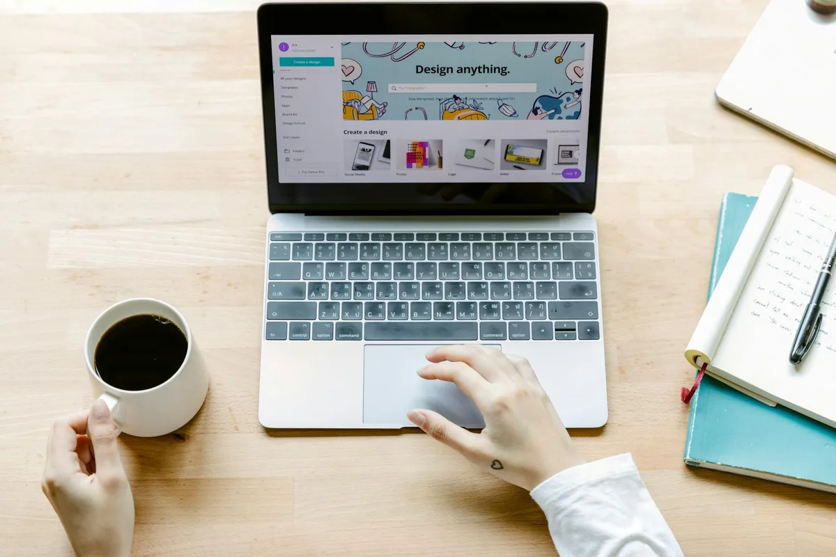 Aerial view of a person using a laptop to work on a digital design