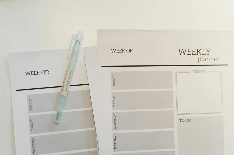 Organized weekly planner printable sheets with a pen — a consistently high-demand Etsy product type