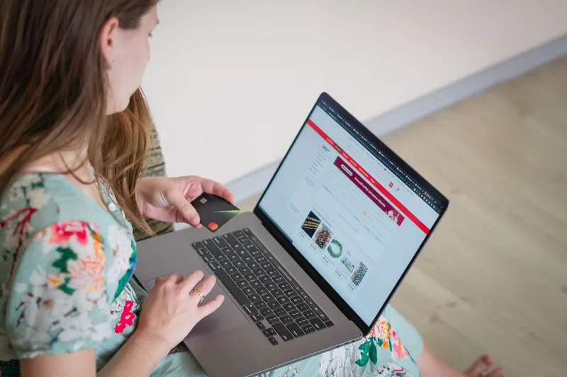 Woman shopping online with a laptop and credit card