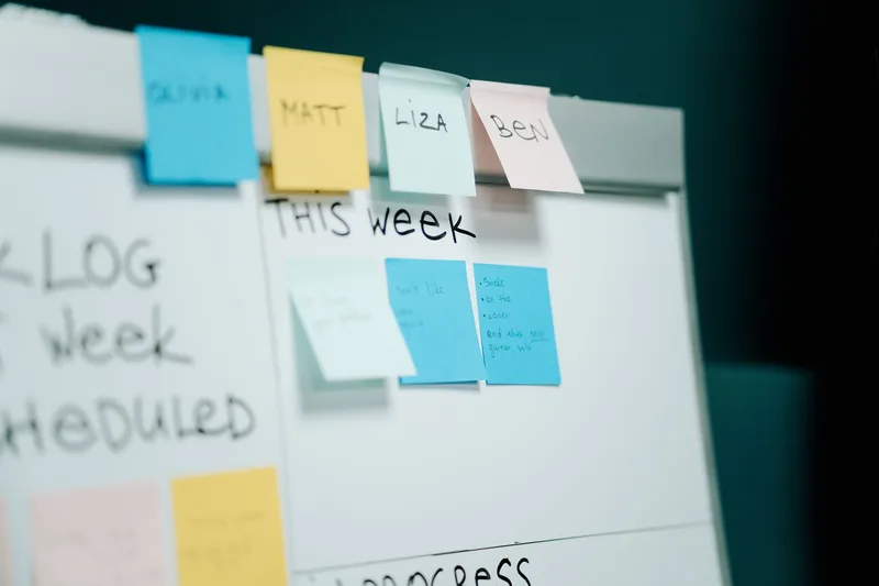 A whiteboard covered in colorful sticky notes, representing how a sales pipeline or task board gets planned out before it becomes a template