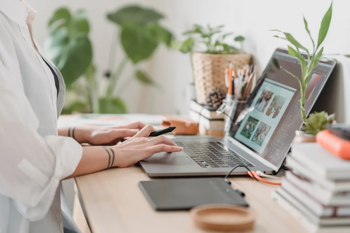 Person working a laptop side job for extra money at a home desk