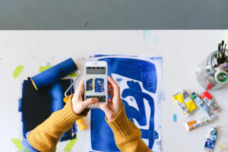 Artist photographing original artwork for upload to print-on-demand marketplace