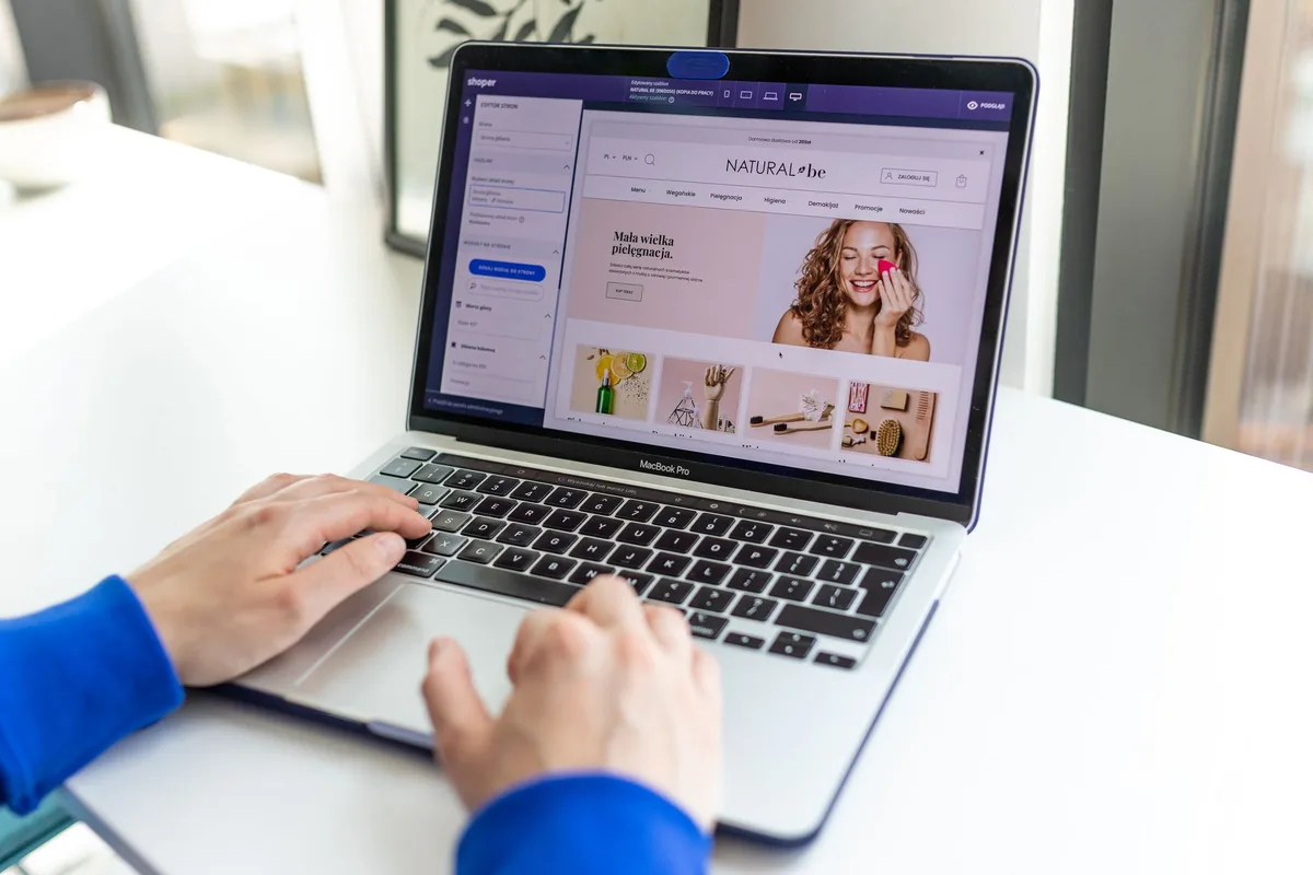 Creator comparing storefront platforms side by side on a laptop